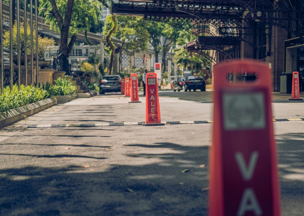 Urban scene in Kuala Lumpur showcasing valet posts on a sunlit street.