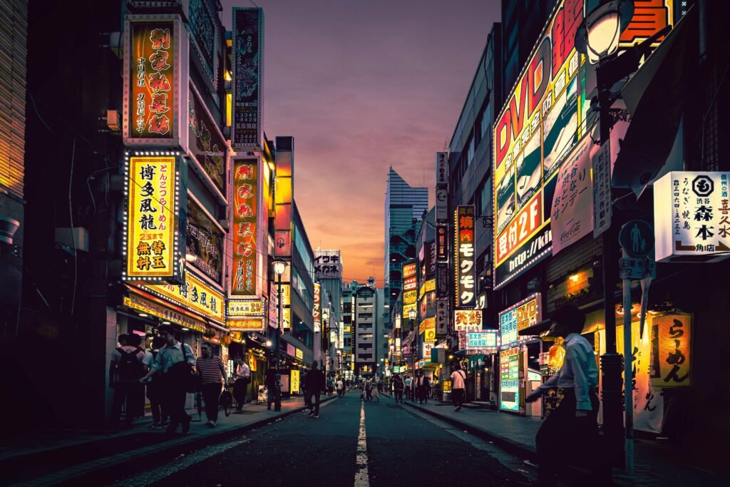 Explore the vibrant nightlife of Shibuya, Tokyo, showcasing neon-lit streets bustling with activity after sunset.