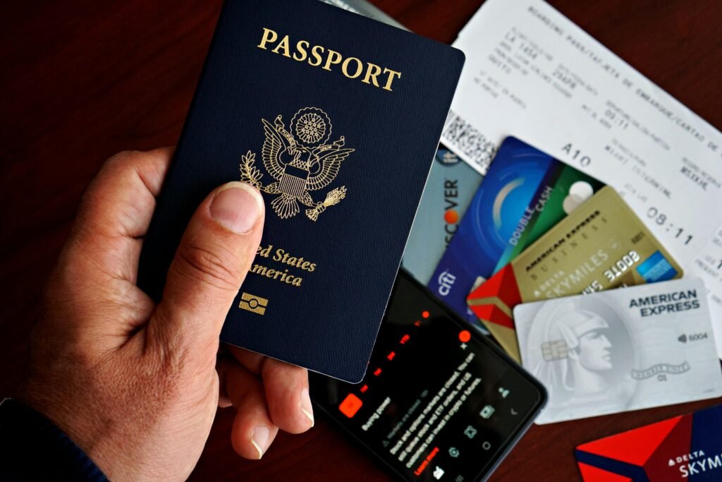 US passport with credit cards and travel documents on a table, travel preparation concept.
