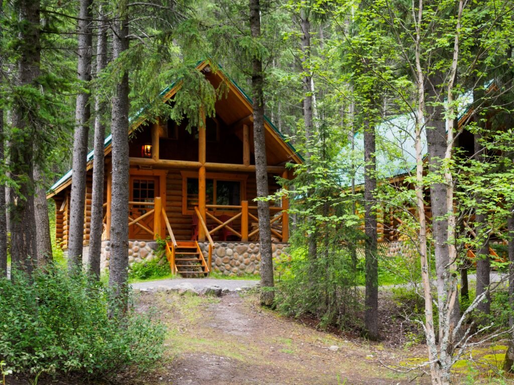 Charming wooden cabin nestled among trees, ideal for a serene forest retreat.